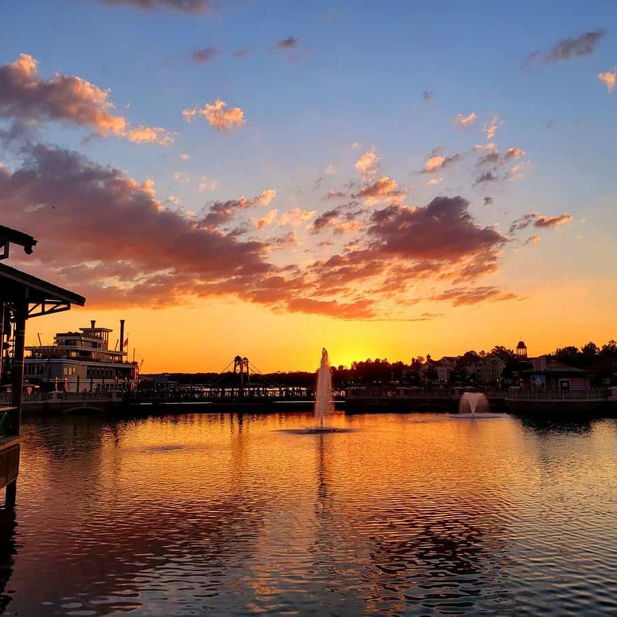 Sunset over Disney Springs with colorful sky reflecting on the water